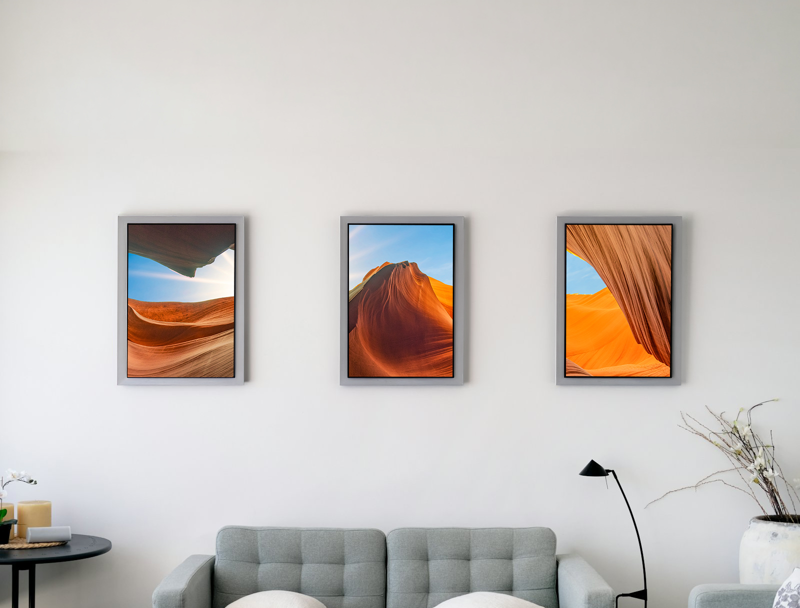 A wall of several displays above a sofa showing one composition